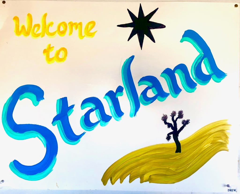 Drew’s hand-painted “Welcome to Starland” sign — a star and a Joshua tree in the desert